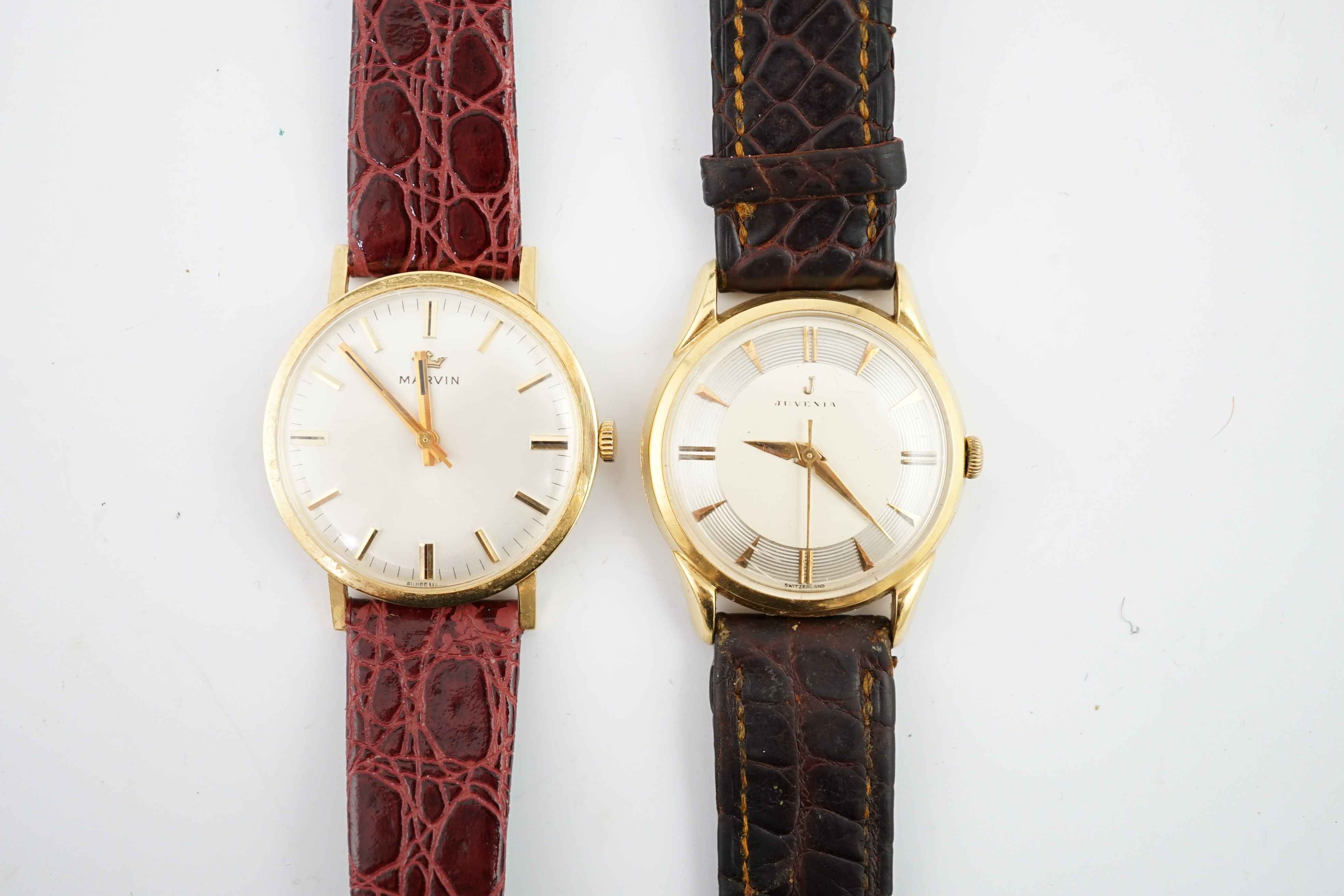 A gentleman's 1960's 18ct? gold Juvenia manual wind wrist watch, on a leather strap and a gentleman's 18ct? gold Marvin manual wind wrist watch, on a leather strap